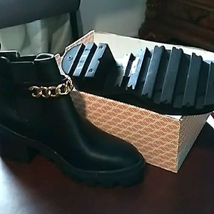 Black booties with gold chain feature
